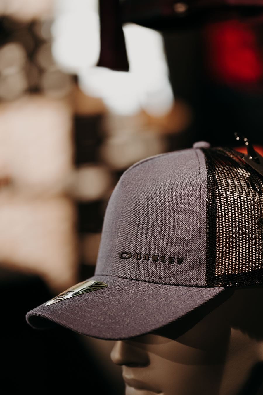Graue Oakley-Mütze auf einem Mannequin-Kopf vor unscharfem Hintergrund