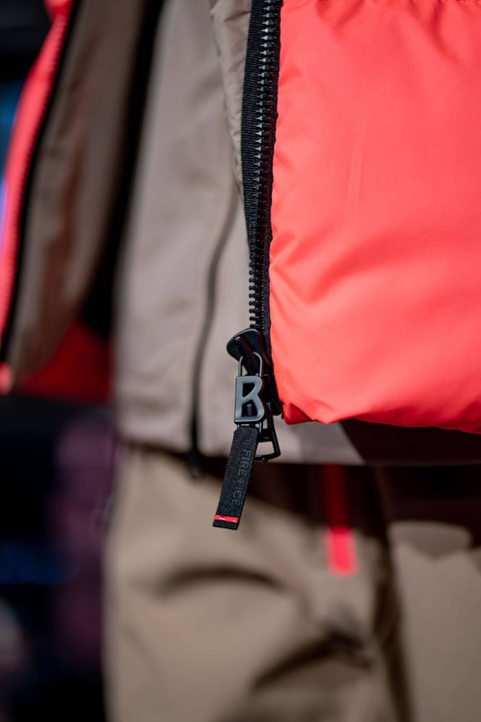 Nahaufnahme eines roten Reißverschlusses mit einem großen schwarzen Zipper an einer Jacke